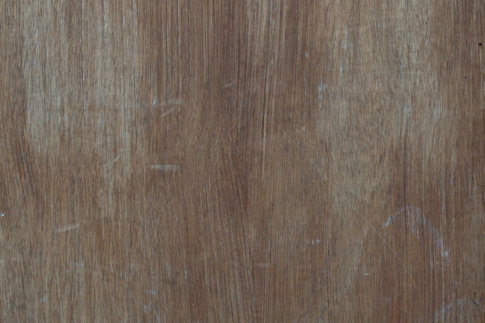 a-close-up-of-a-wooden-surface-with-scratches.jpg a close up of a wooden surface with scratches